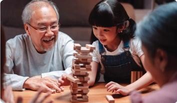 a person and a child playing a board game