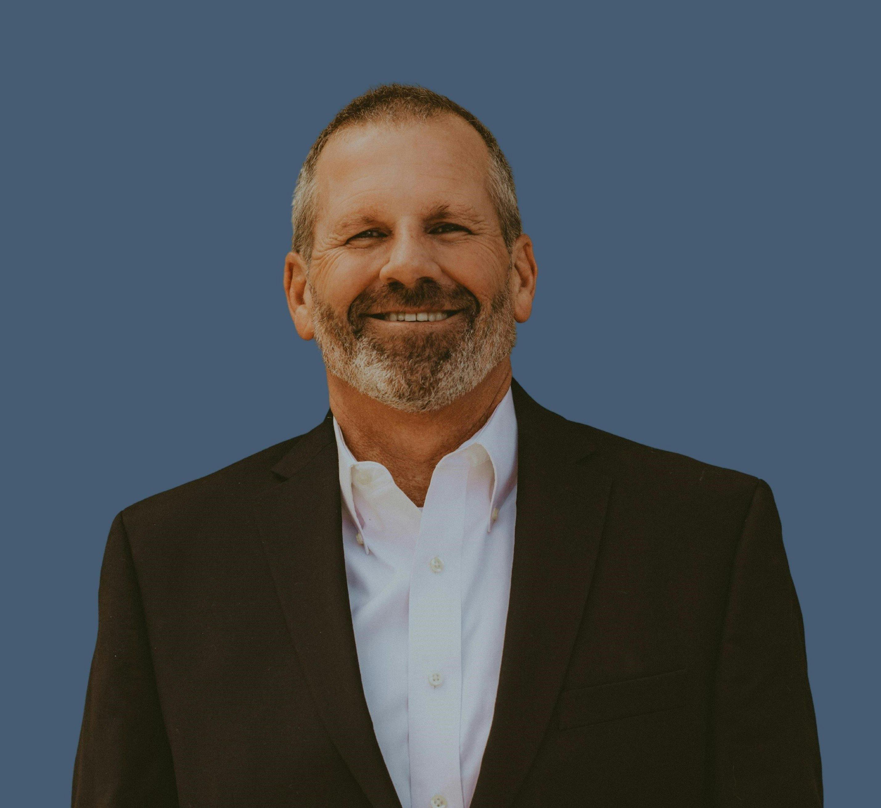 a man in a suit smiling