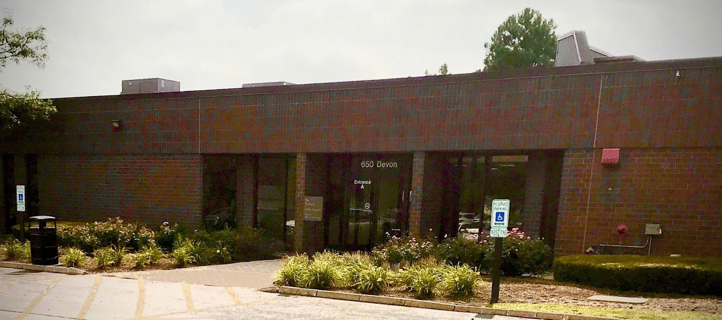 a brick building with a sign in front of it