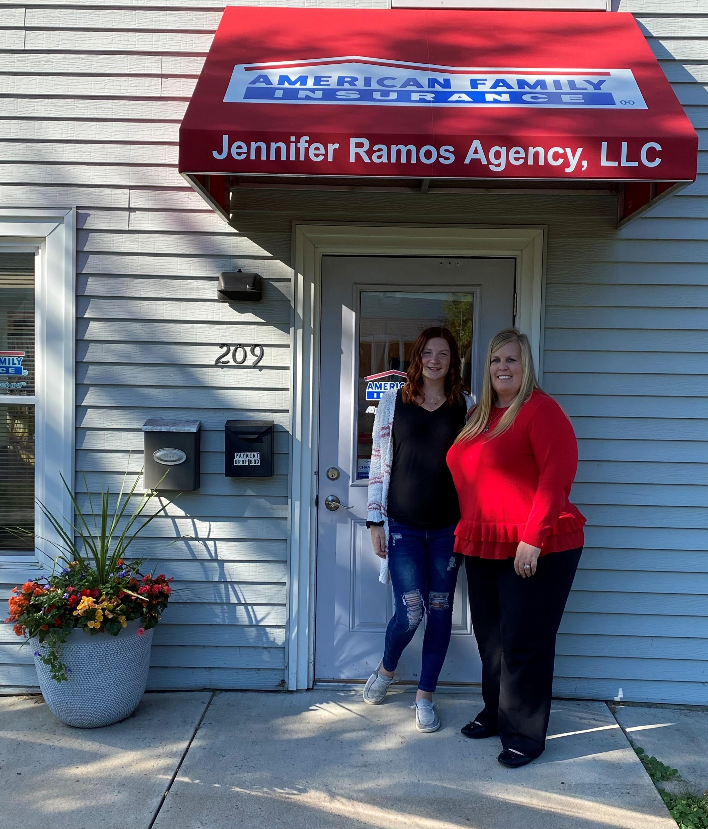 two women standing in front of a building