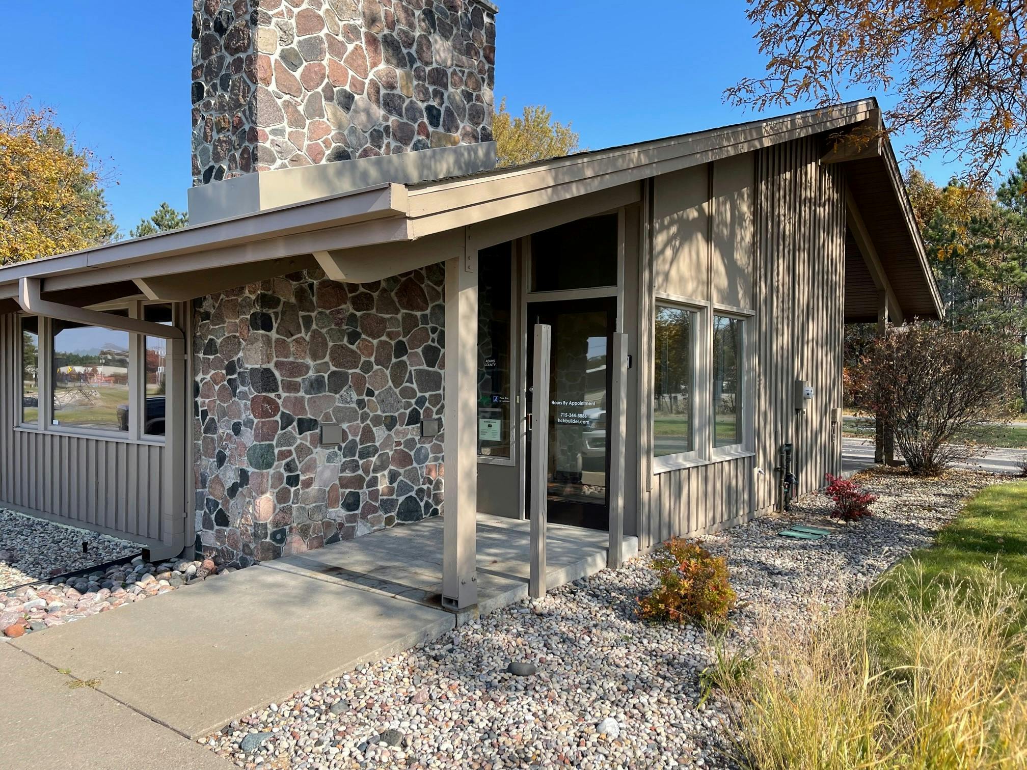 a house with a stone wall