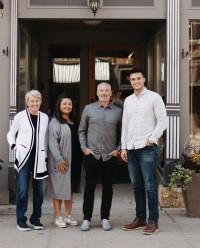 a group of people posing for a photo in front of a door