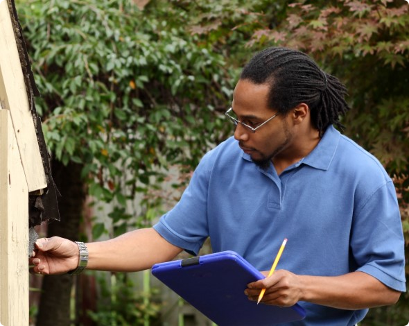 An insurance agent inspecting a home's roof damage.