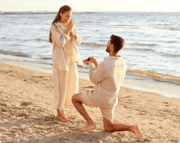 A newly engaged couple on the beach.