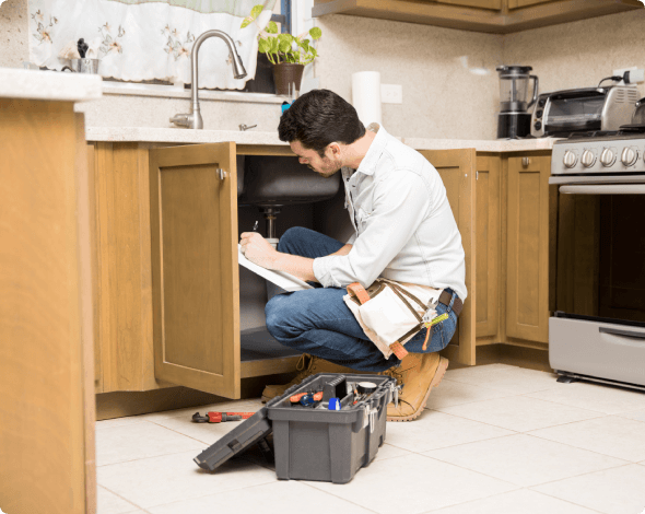 Handyman working on a kitchen sink