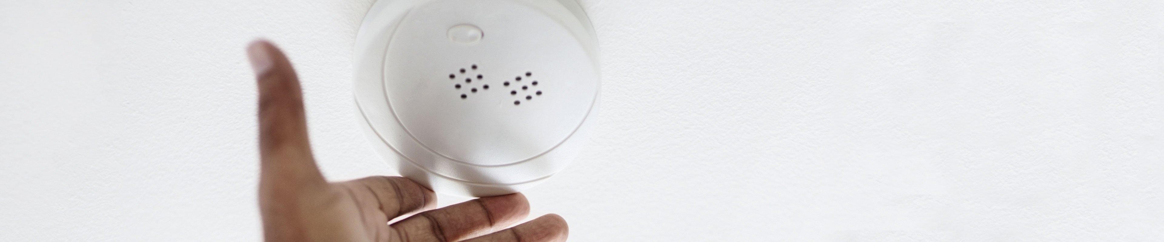 Man installing a smart smoke detector