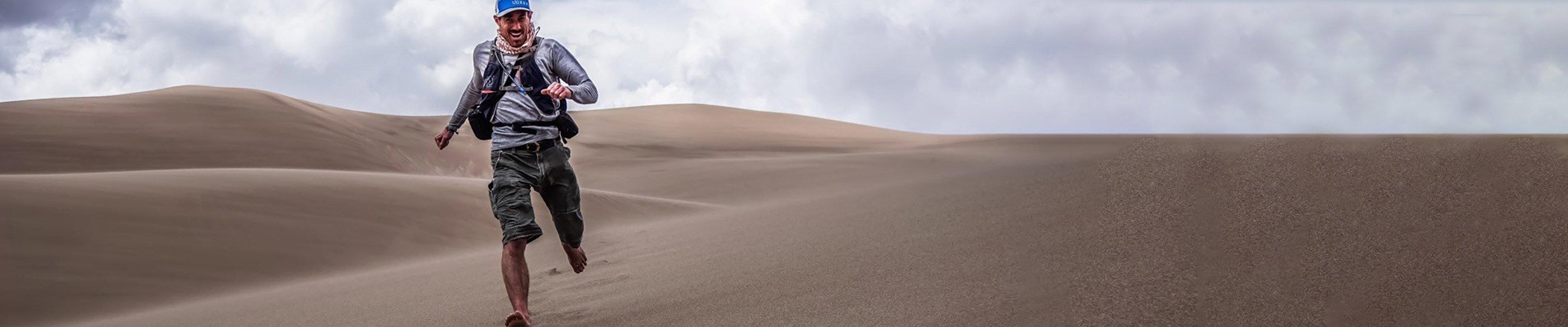 Rob Harsh from Awakened Adventures running through the desert.