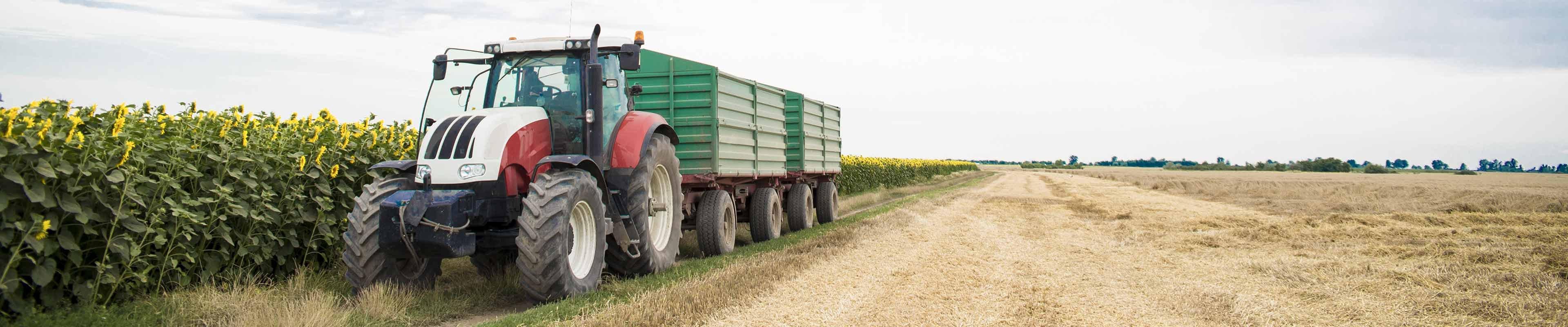 Image of a tractor pulling a farm trailer.