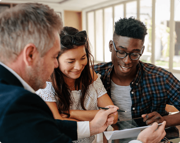 a couple reviewing paperwork with an agent