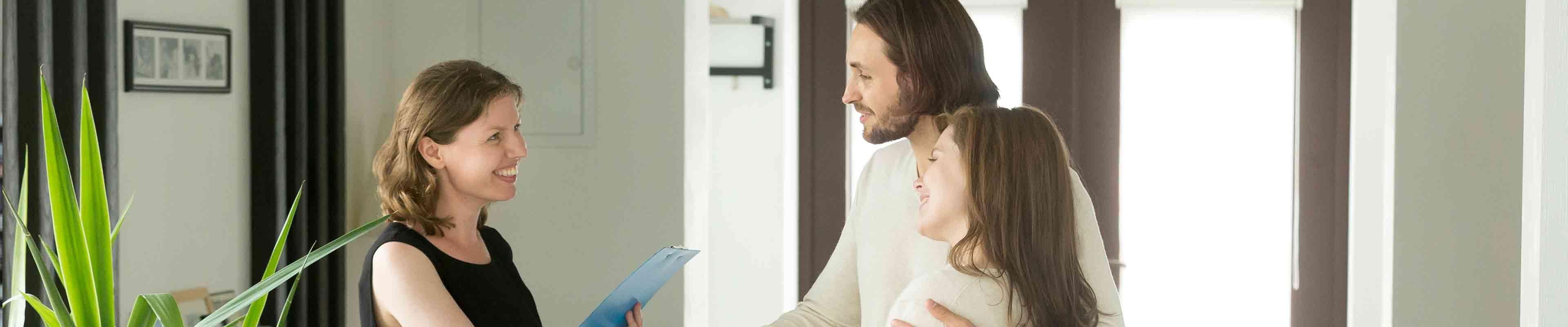 A landlord shows potential tenants around an apartment after they viewed her rental listing.