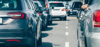 Cars lined up in a heavy traffic