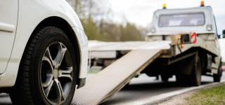 Car getting towed on the side of a road