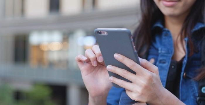 a woman holding a phone