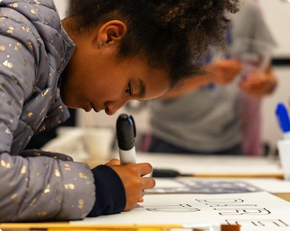 Girl writing with a sharpie